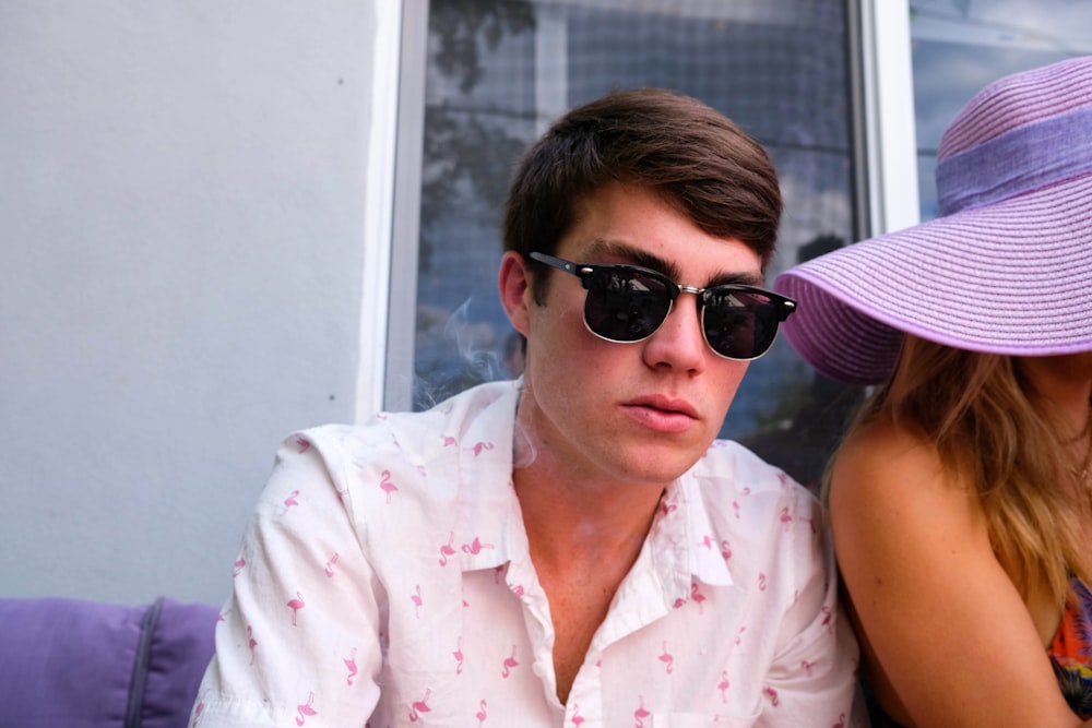 man in white and pink button up shirt wearing black sunglasses