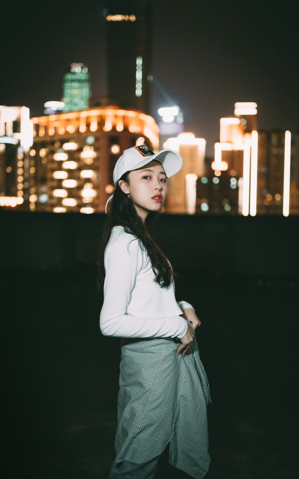 woman in white long sleeve shirt and gray skirt wearing black sunglasses