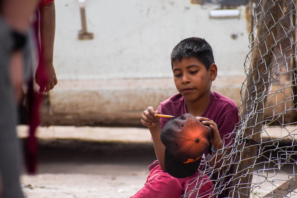 boy in red t-shirt holding basketball