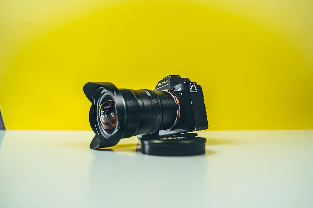 black dslr camera on white table