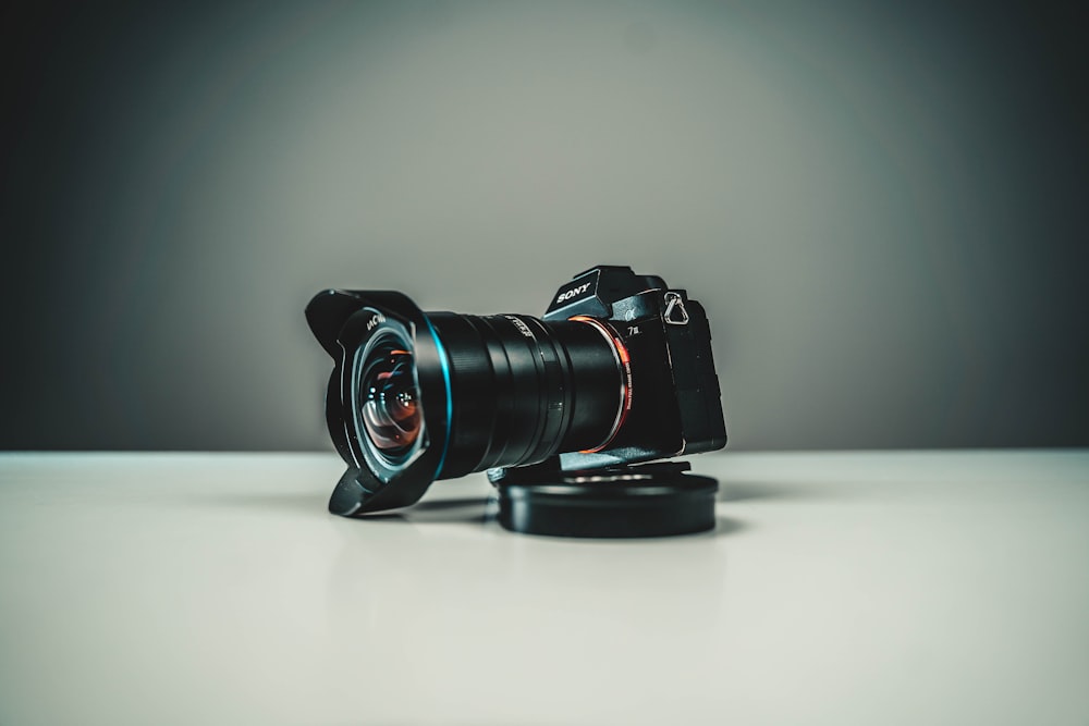 black nikon dslr camera on white table