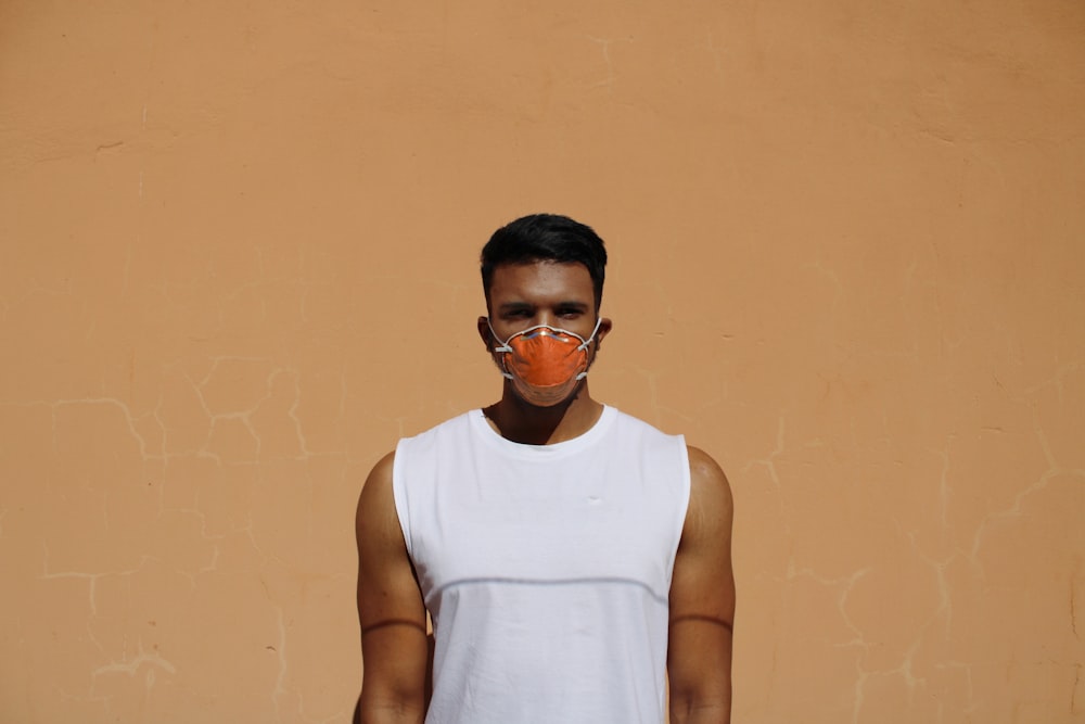 man in white tank top wearing black sunglasses