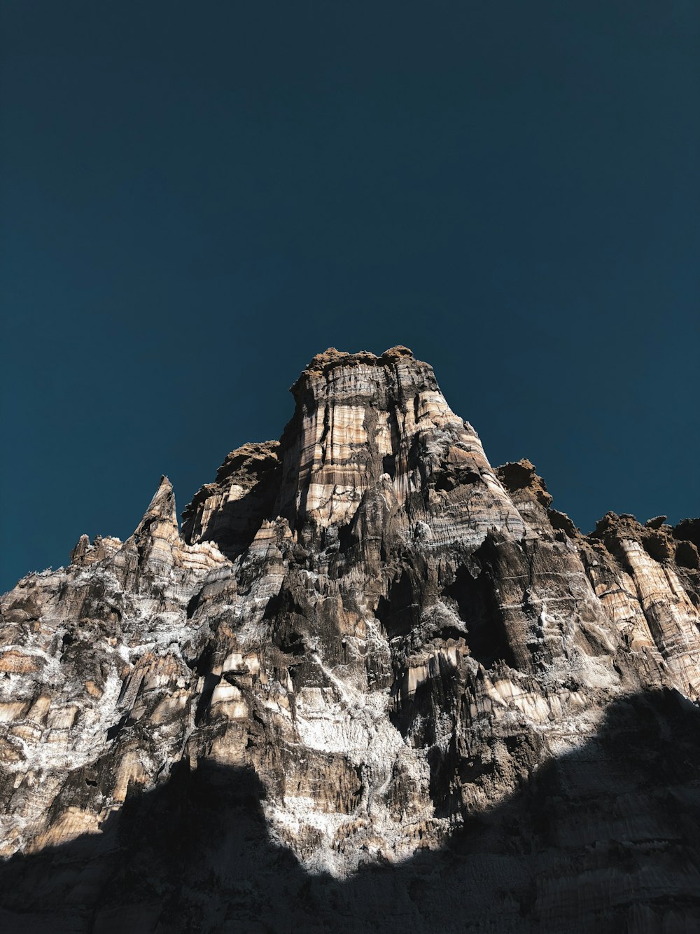 brown and white rock formation under blue sky during daytime