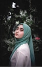 woman in green hijab standing near green plants