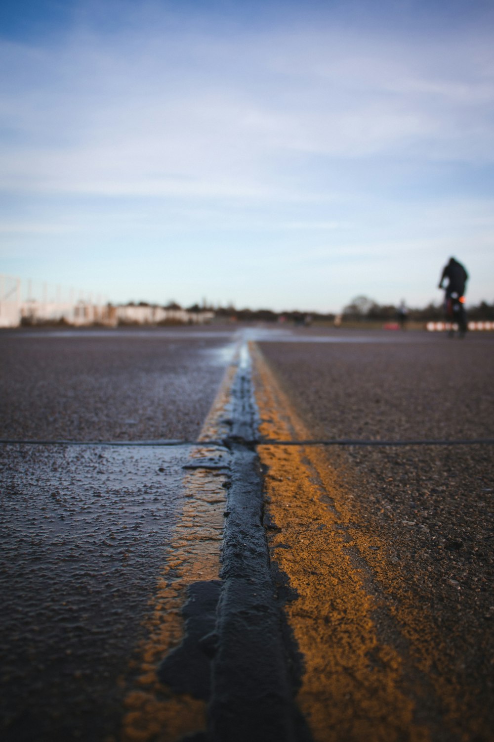 person walking on gray concrete road during daytime