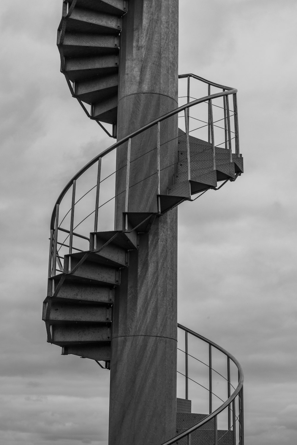 grayscale photo of spiral staircase