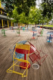 red and blue wooden chairs on brown wooden floor