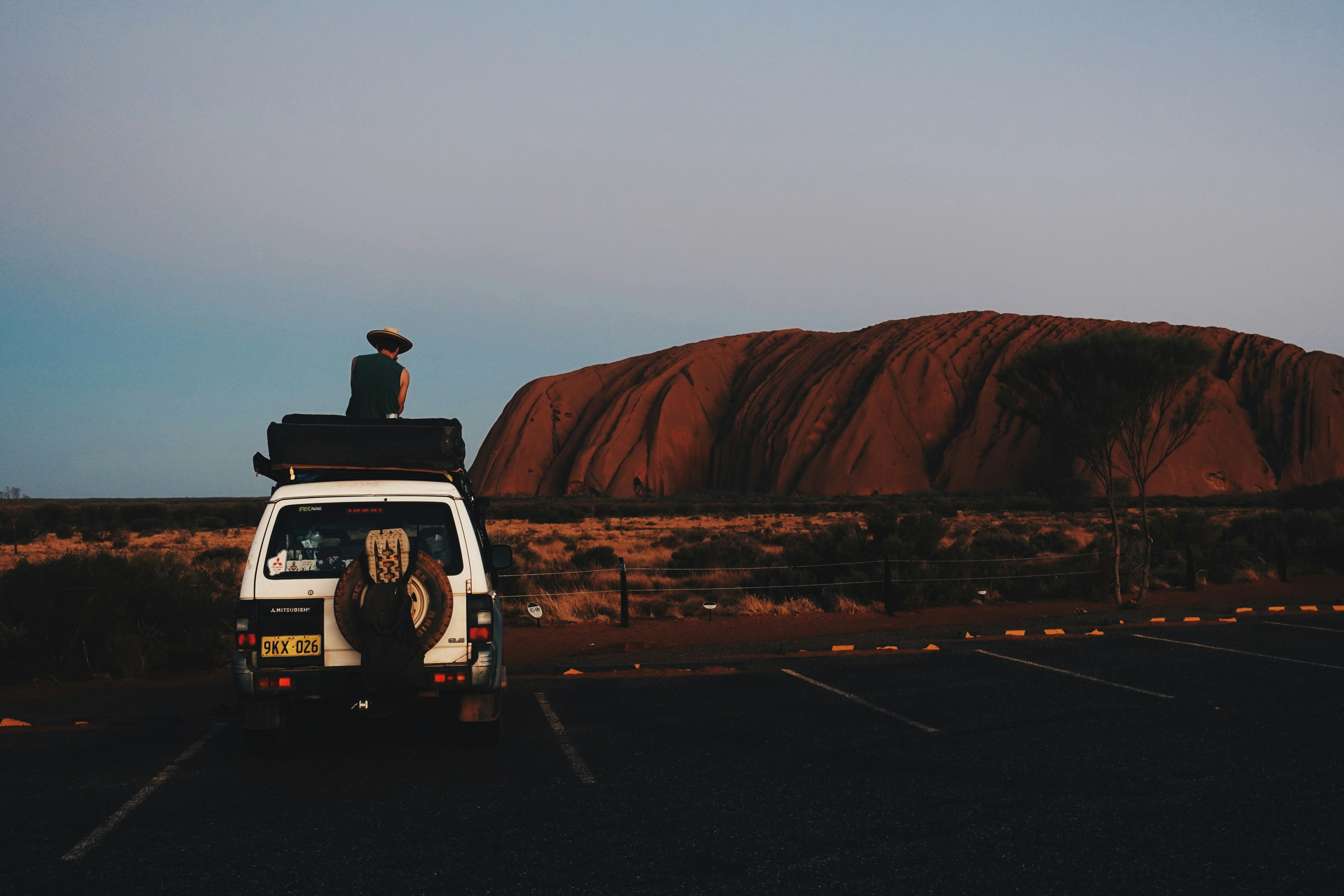 black suv on road near brown mountain during daytime