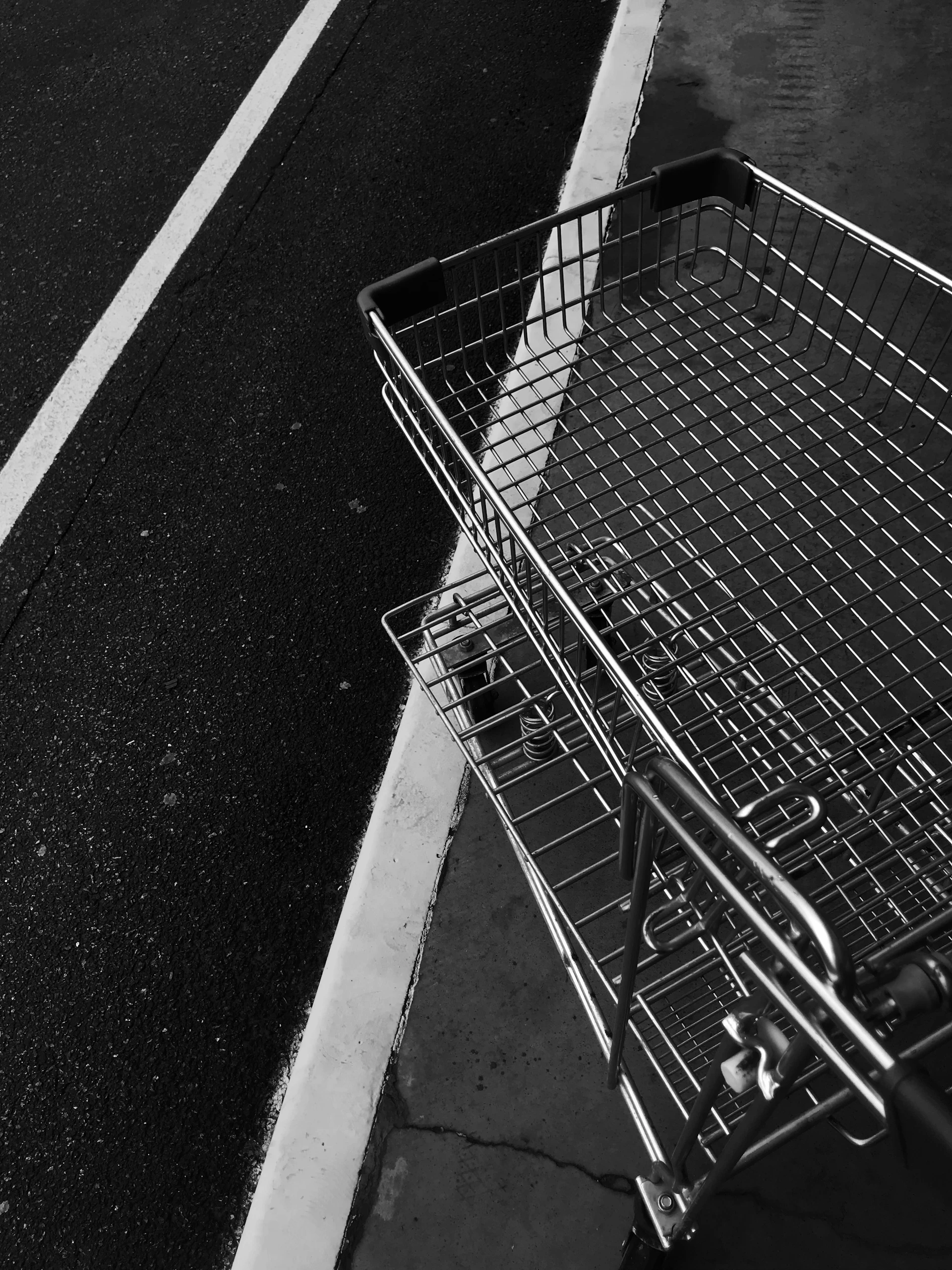gray metal shopping cart on gray concrete floor