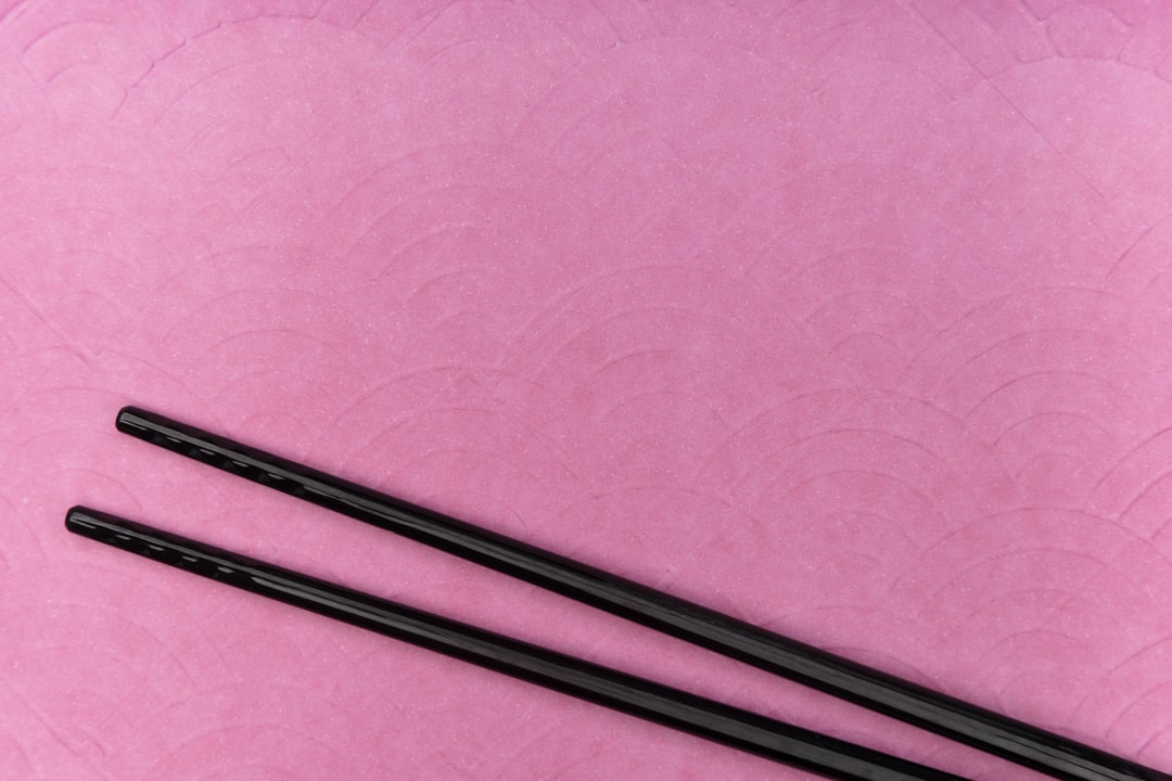 black metal rod on pink textile