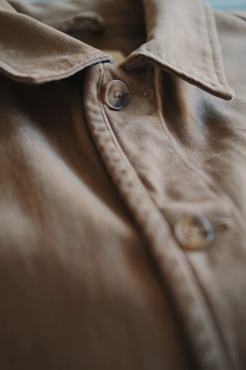 Close-up of a stylish shirt collar with buttons in a natural light