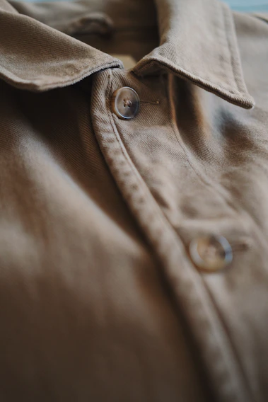 Close-up photo of a sleek, custom-made modern shirt with subtle textures highlighting fabric quality.