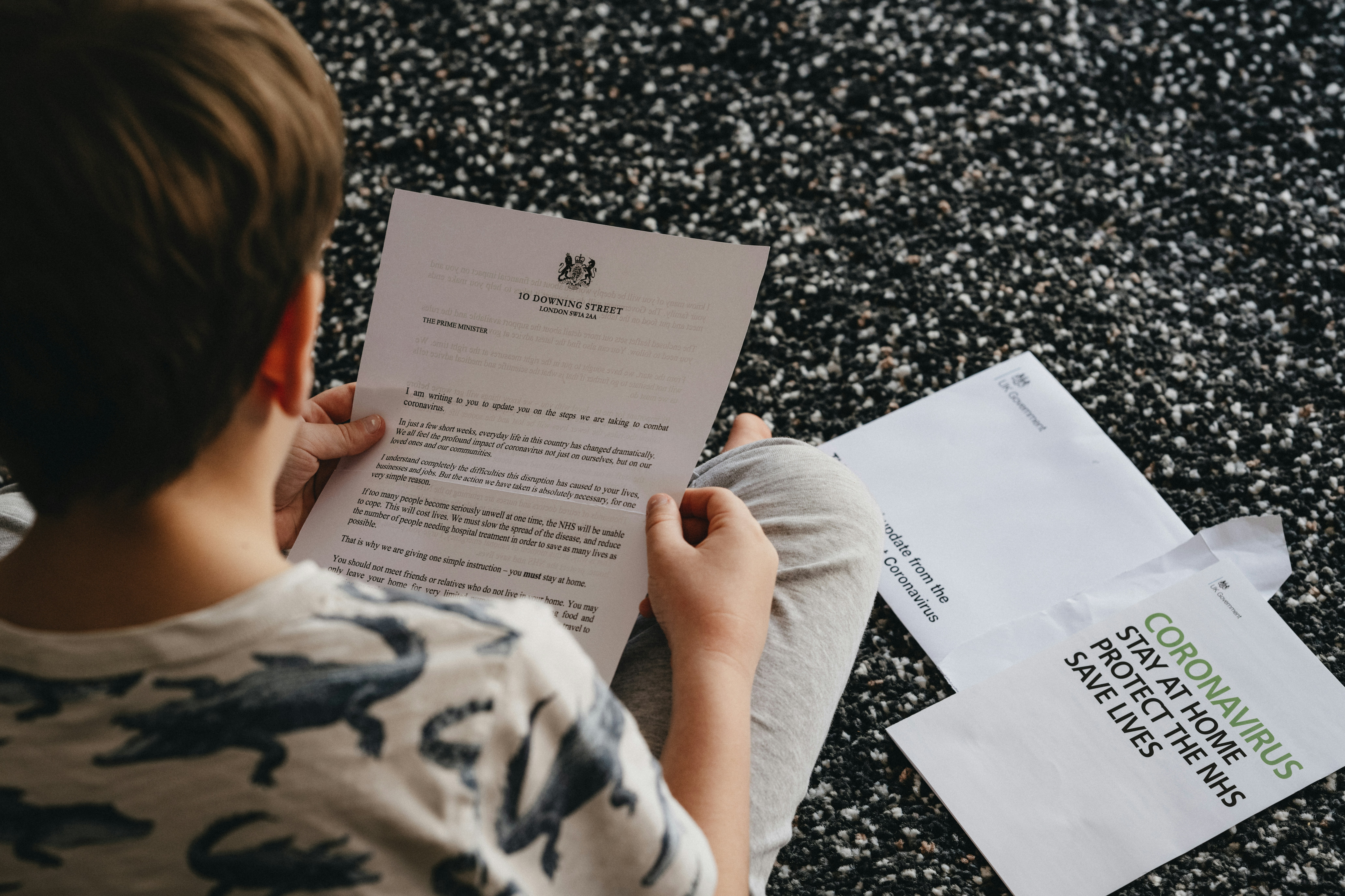 Child reading UK Coronavirus latter from Boris Johnson