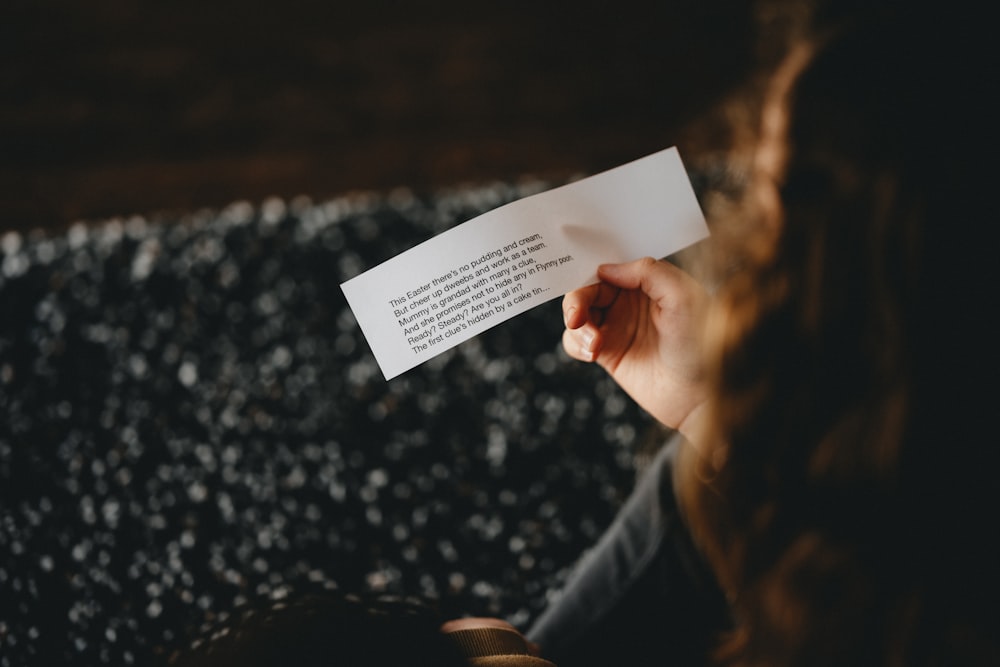 person holding white printer paper