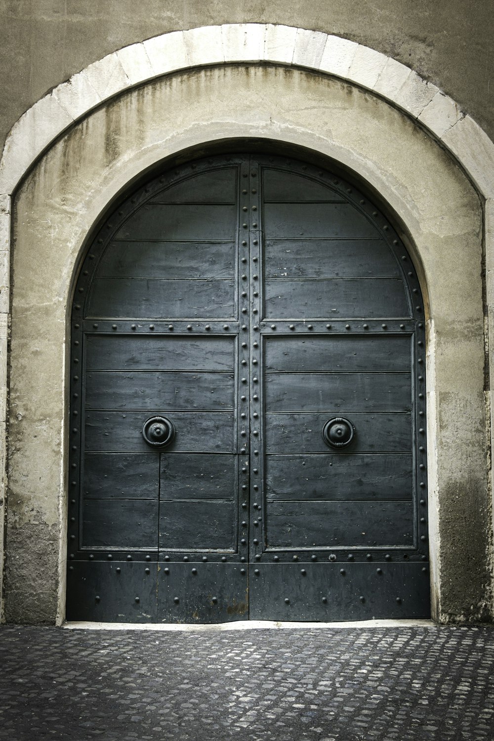 blue wooden door on brown concrete wall