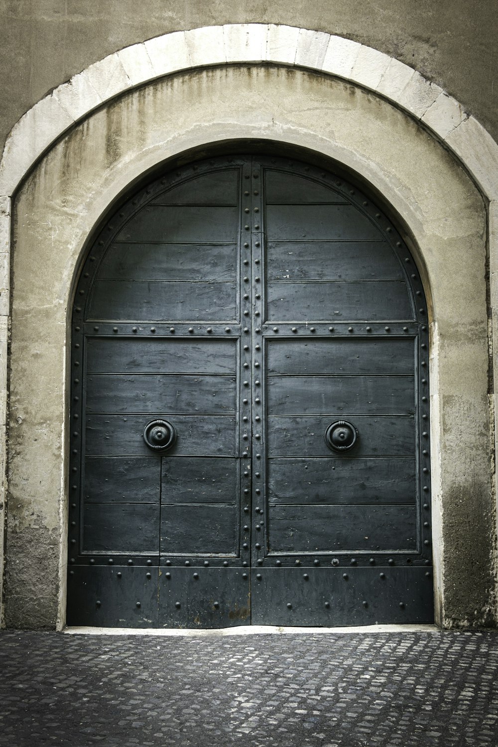 茶色のコンクリートの壁に青い木製のドア