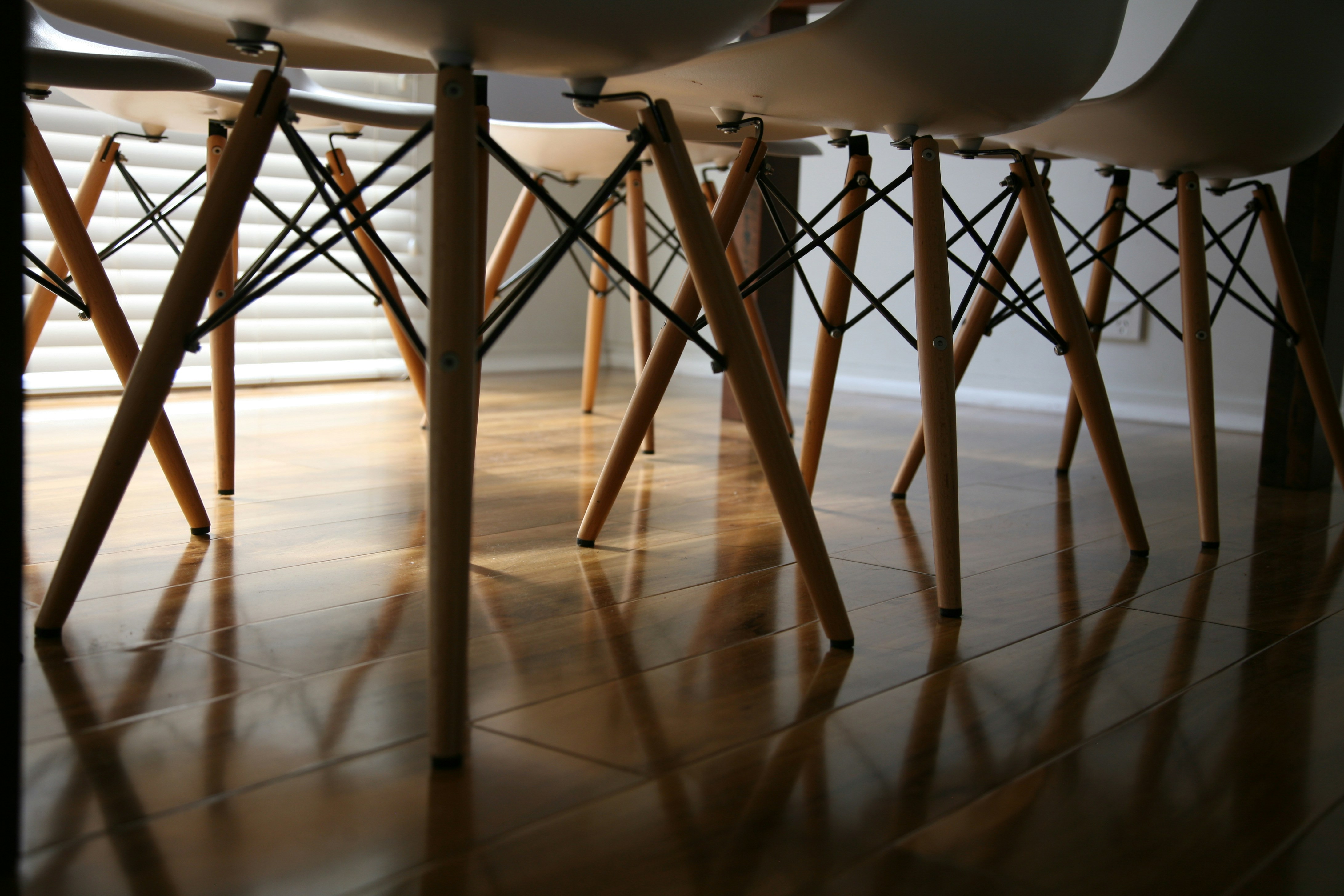 brown wooden bar stools on white floor tiles