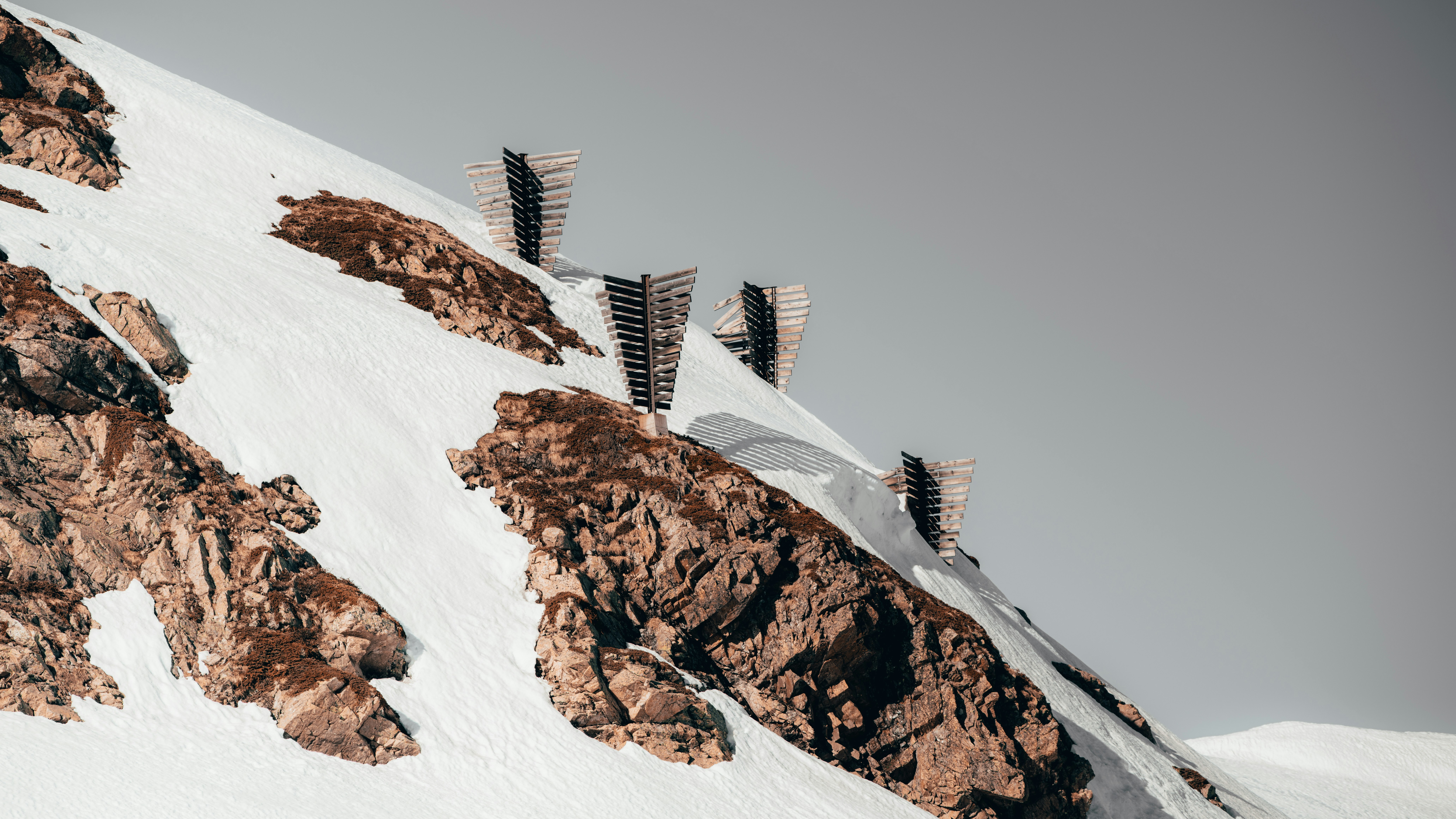 white and brown house on white snow covered mountain