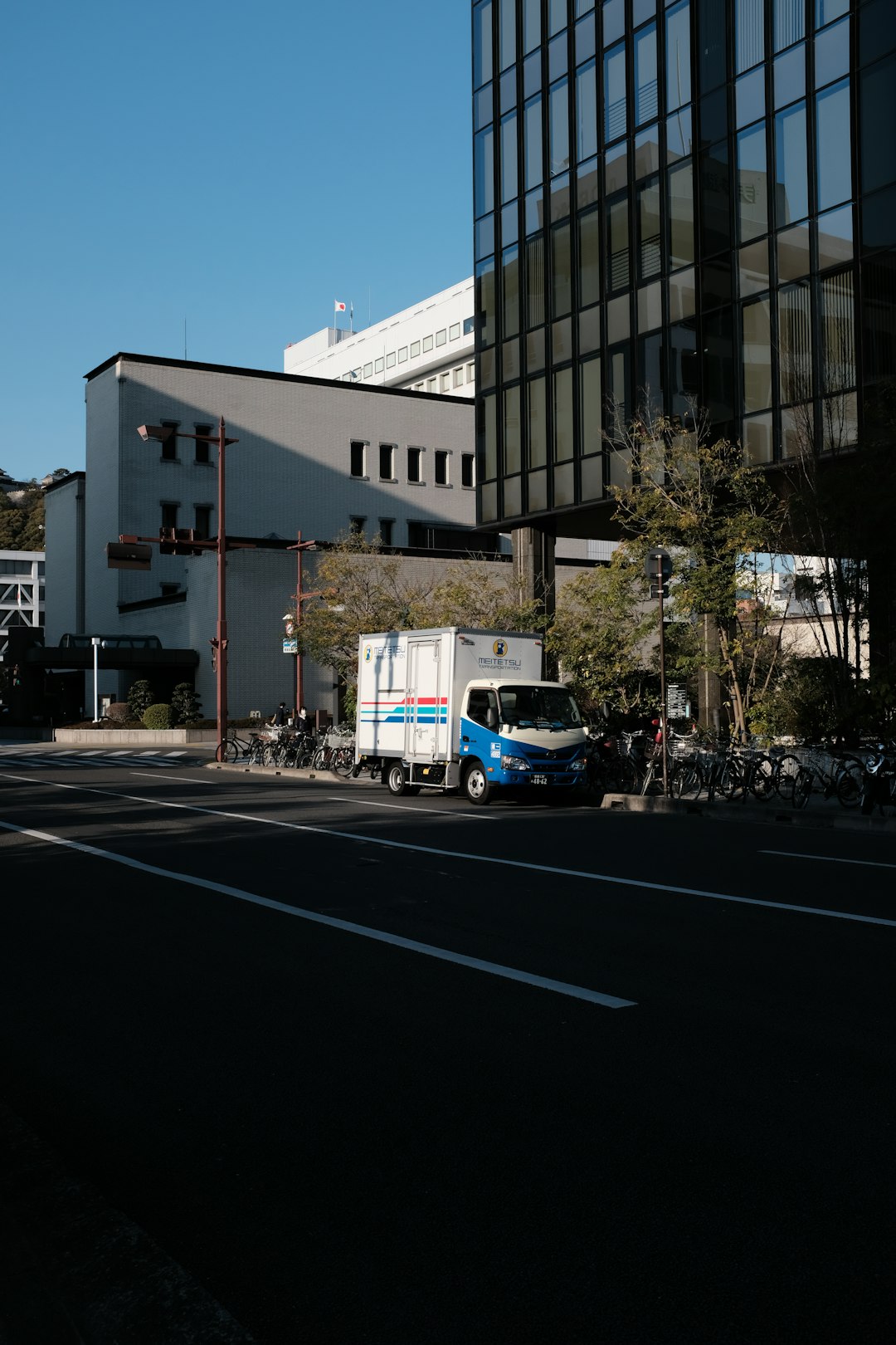 white van parked near white concrete building during daytime