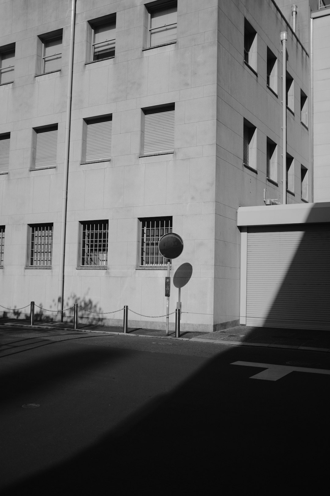 grayscale photo of street light near building