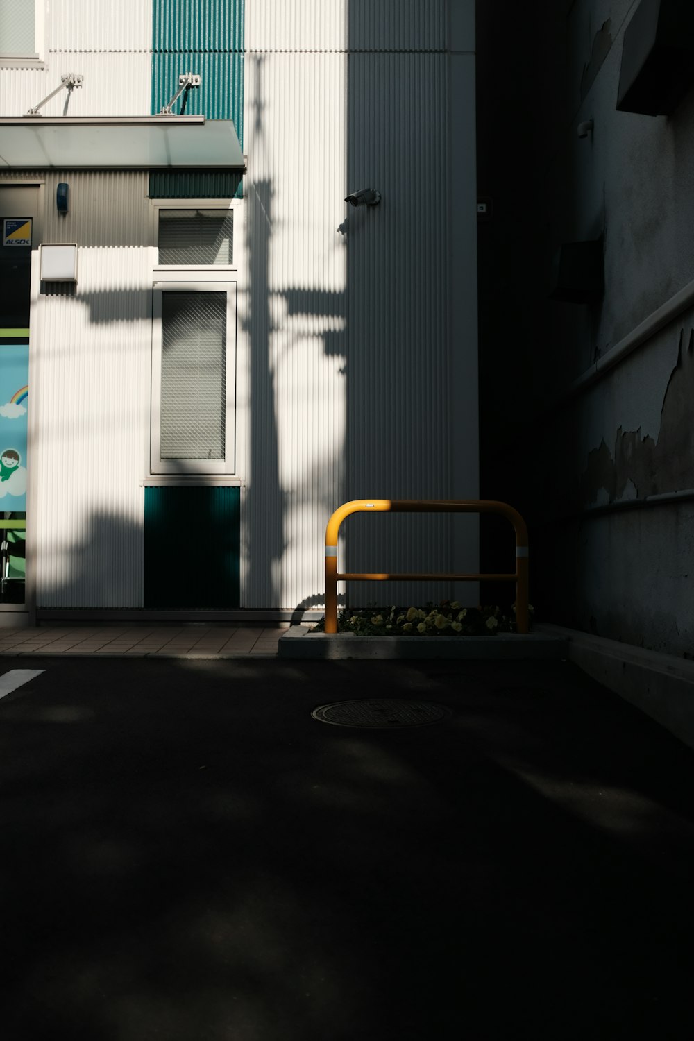 yellow and black metal chair near white and green wooden door