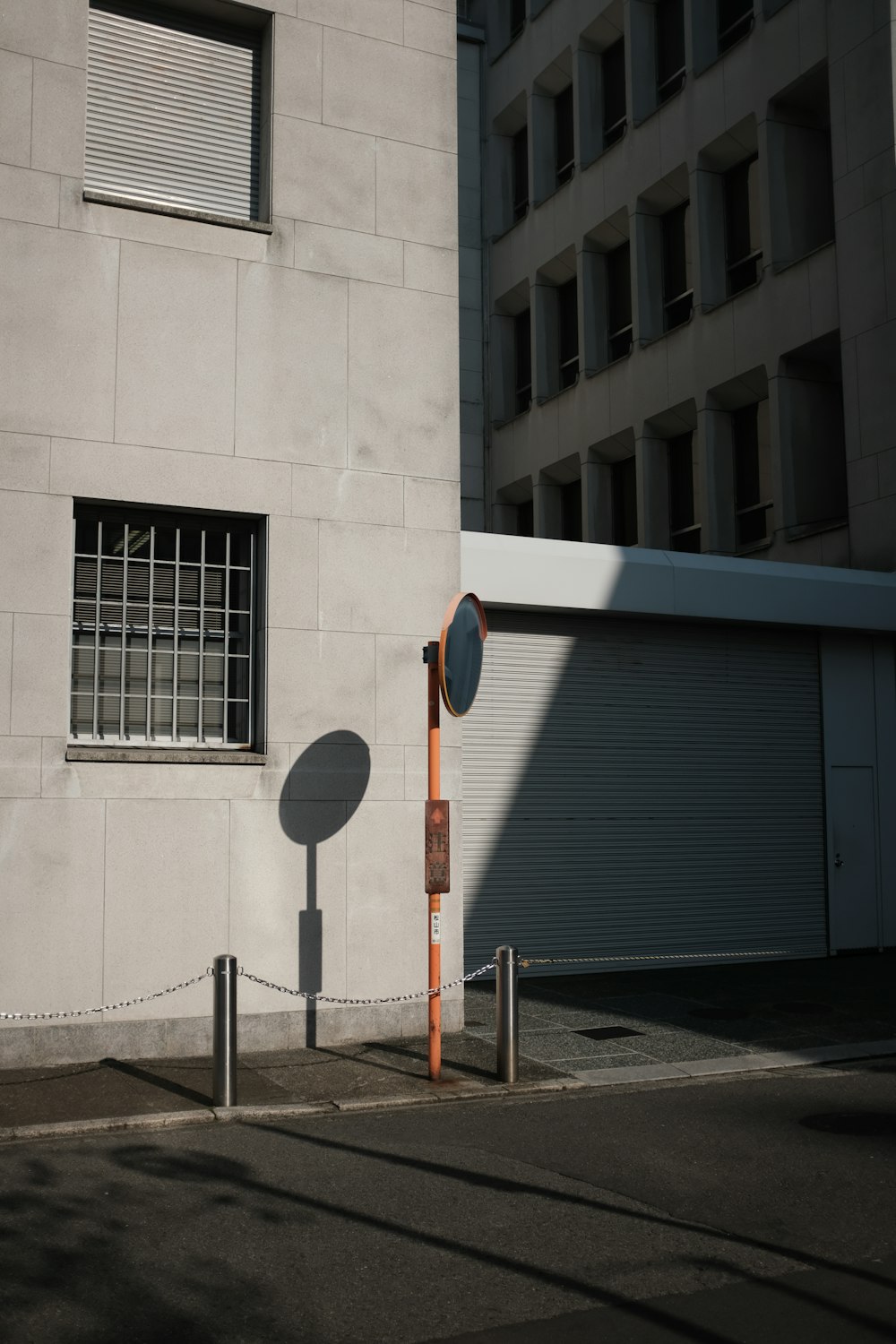 white and red street sign near blue building during daytime