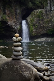 gray stone near body of water during daytime