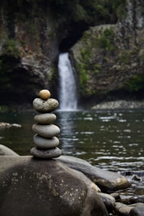 gray stone near body of water during daytime