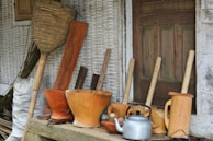 A set of traditional pital utensils arranged on a rustic wooden table.