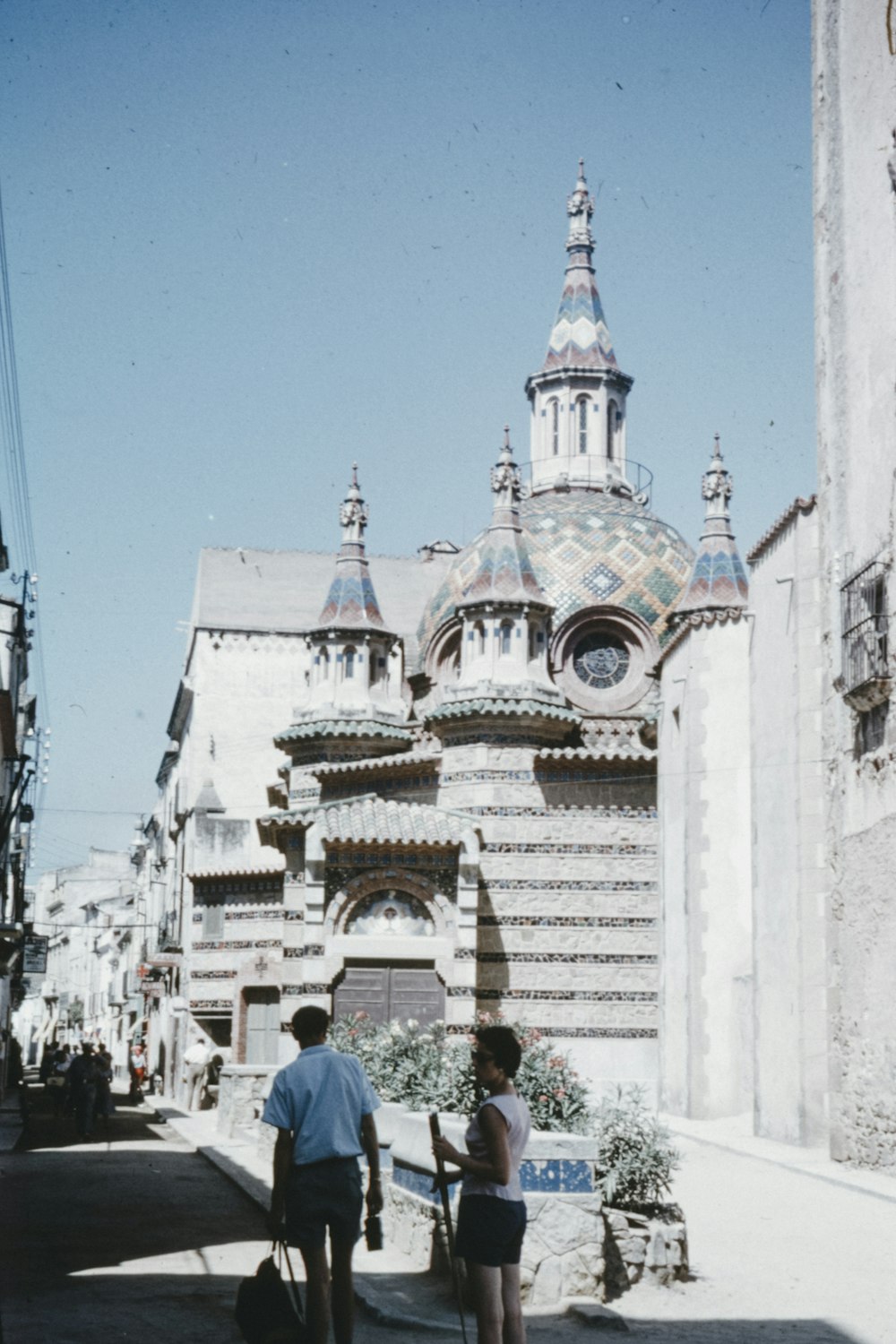 people walking on street near white and brown concrete building during daytime