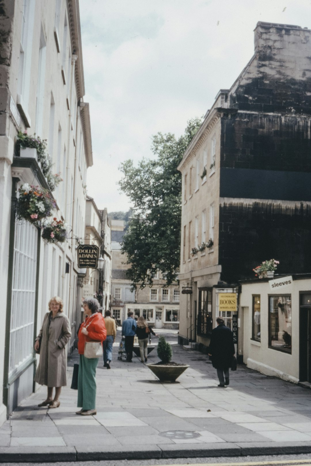 people walking on sidewalk near building during daytime