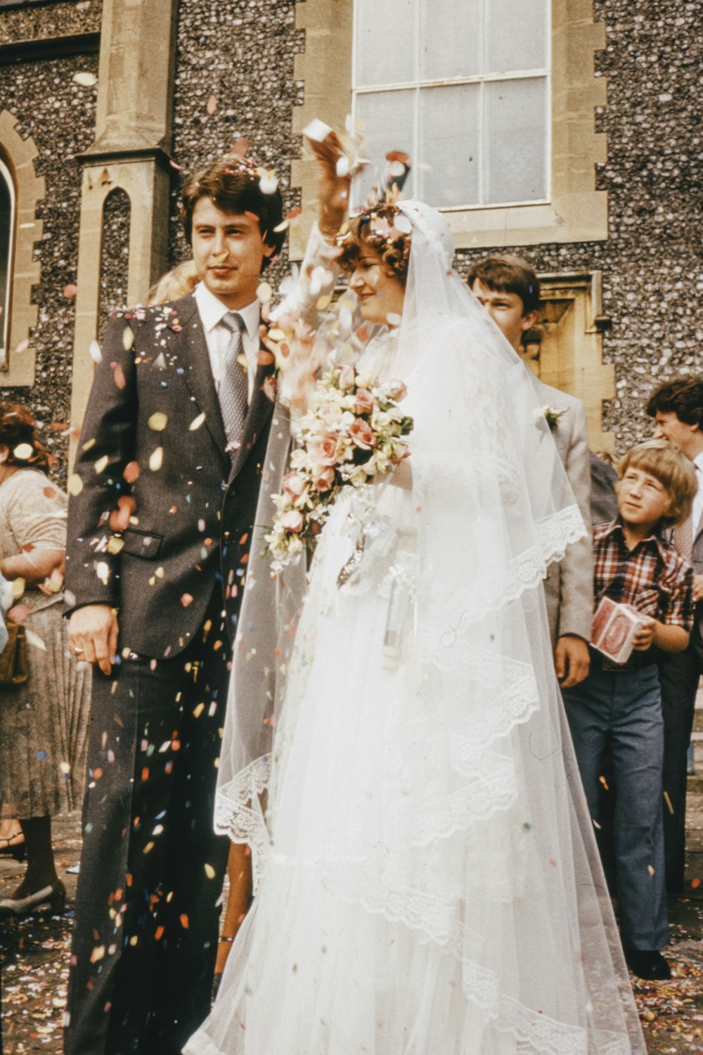 woman in white wedding gown holding bouquet of flowers