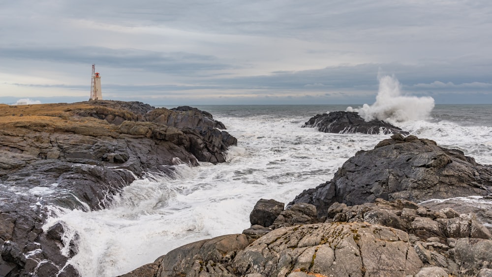 brown rock formation on sea during daytime