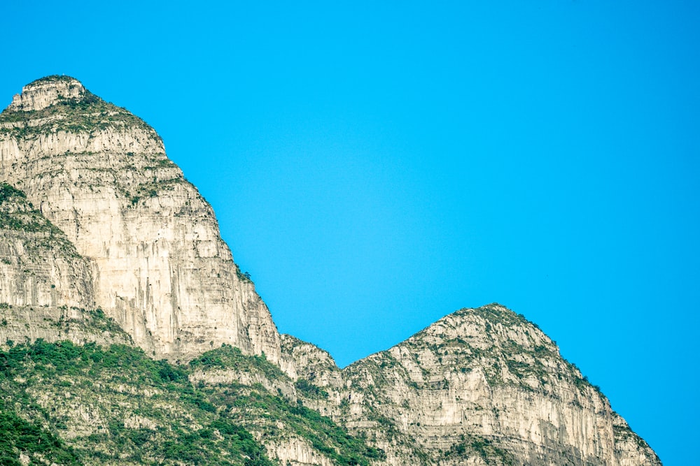 gray rocky mountain under blue sky during daytime