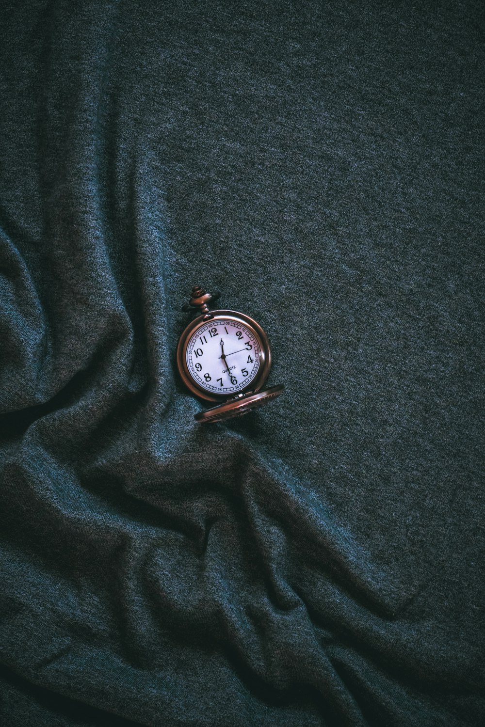 silver pocket watch at 10 00