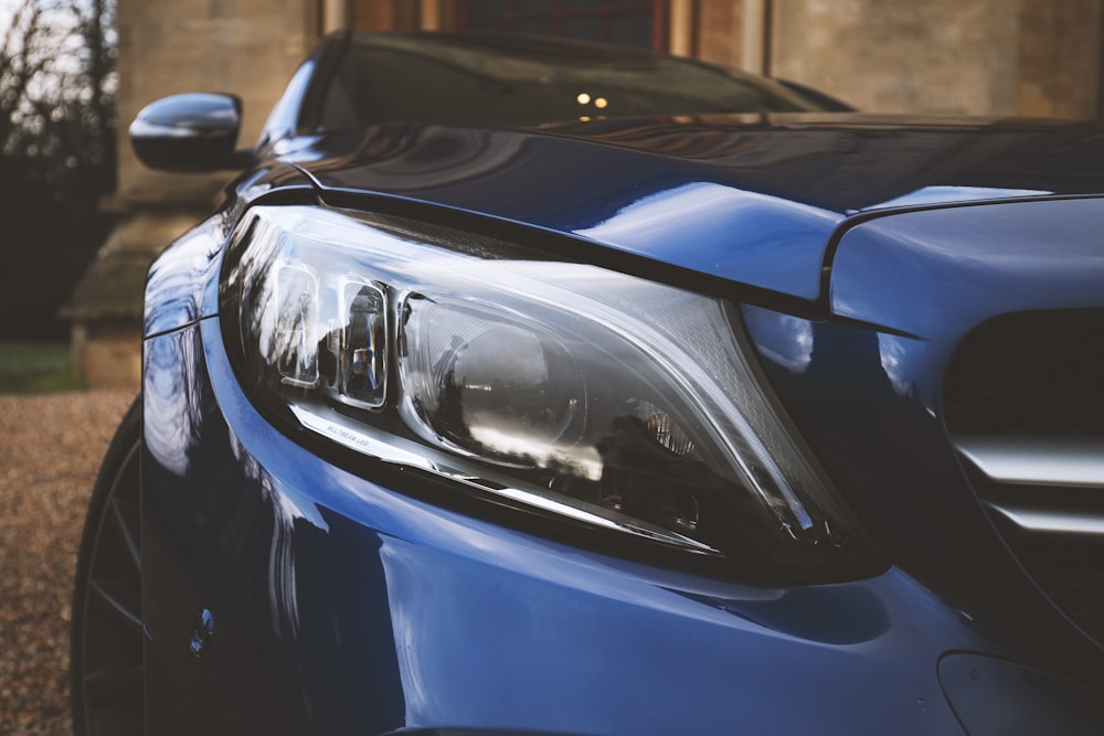 blue and silver car in front of white car