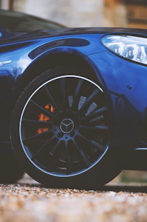 Artistic shot of a luxury car's polished wheel and brake system highlighting craftsmanship