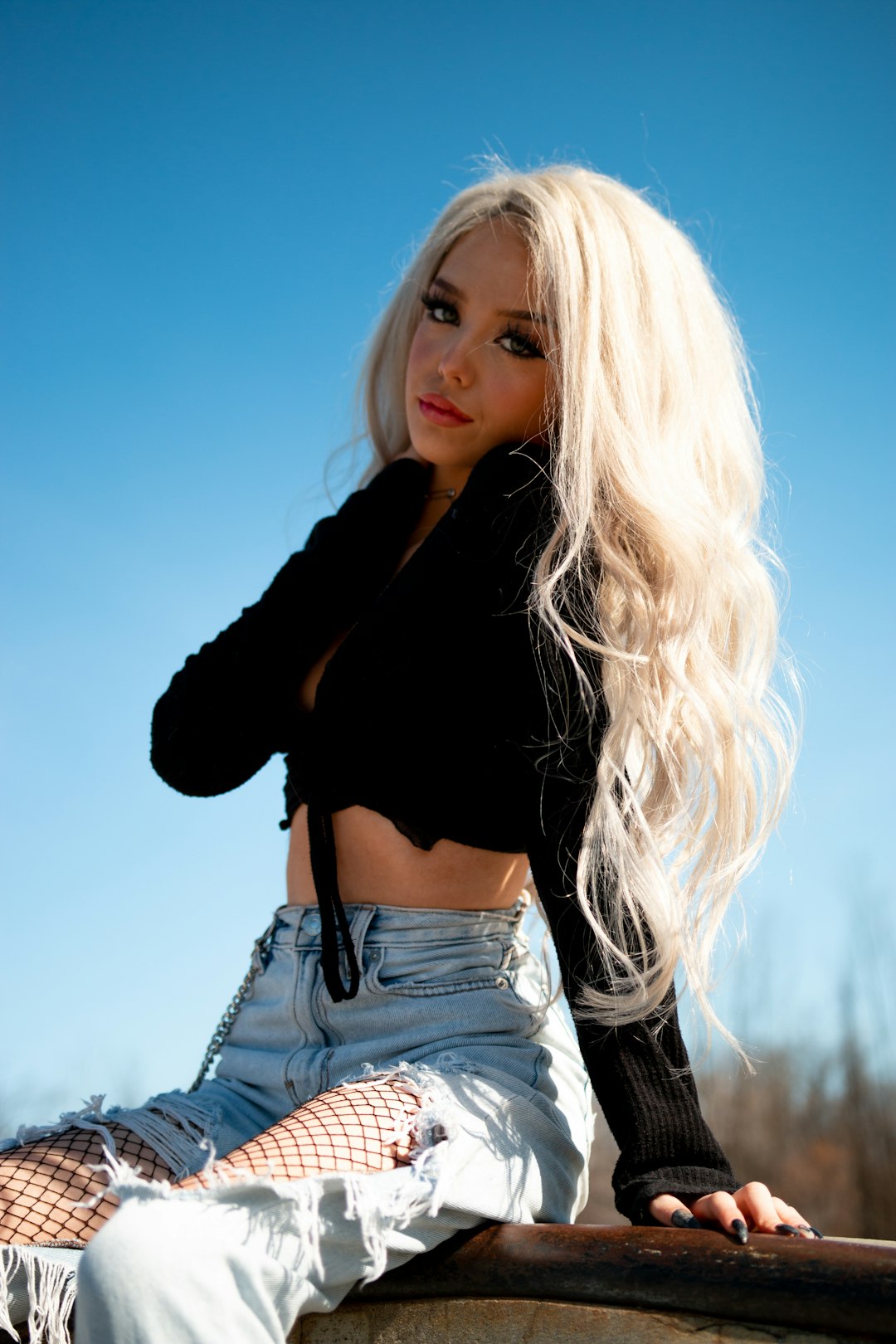 woman in black long sleeved shirt and blue denim skirt