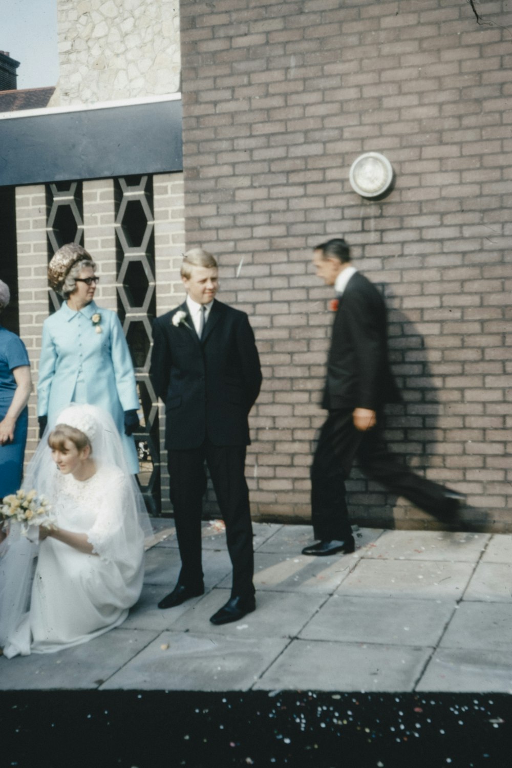 man in black suit jacket standing beside woman in white wedding dress