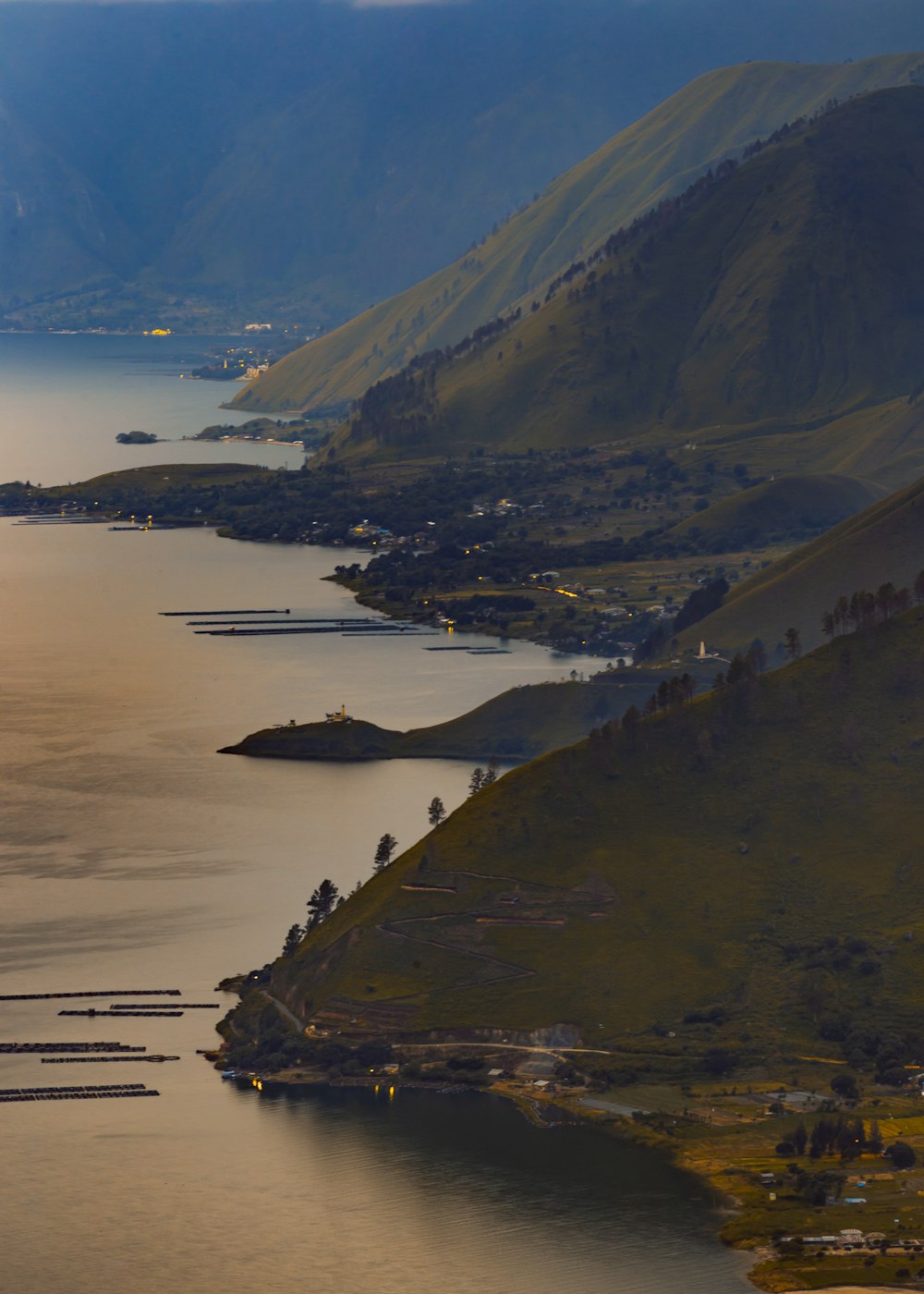 aerial view of mountain near body of water during daytime