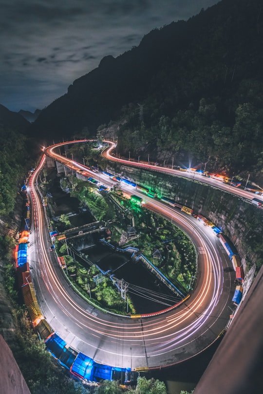 time lapse photography of cars on road during night time in Jalan Kelok Sembilan Indonesia