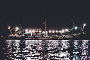 Bright marine LED lighting illuminating a boat deck at dusk with gentle reflections on the water