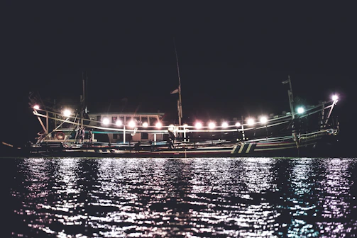 Bright marine LED lighting illuminating a boat deck at dusk with gentle reflections on the water