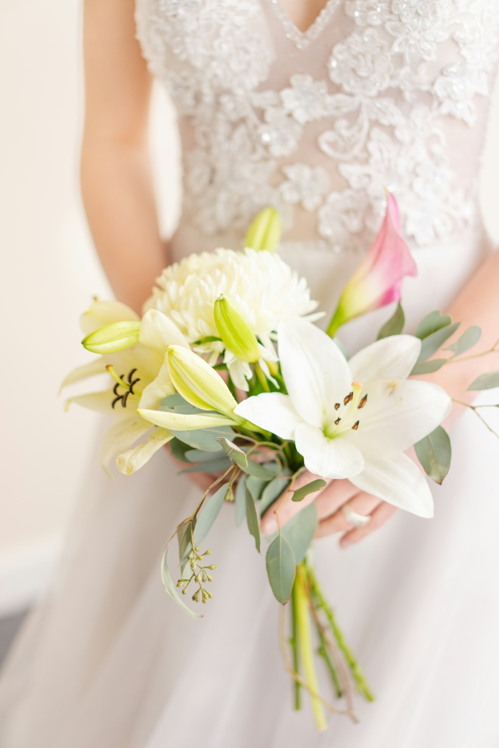 woman in white floral dress holding white flower