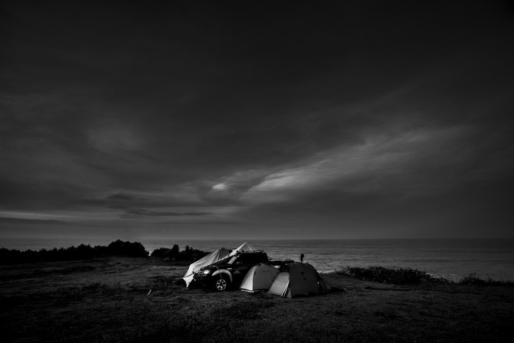 grayscale photo of a car on a field
