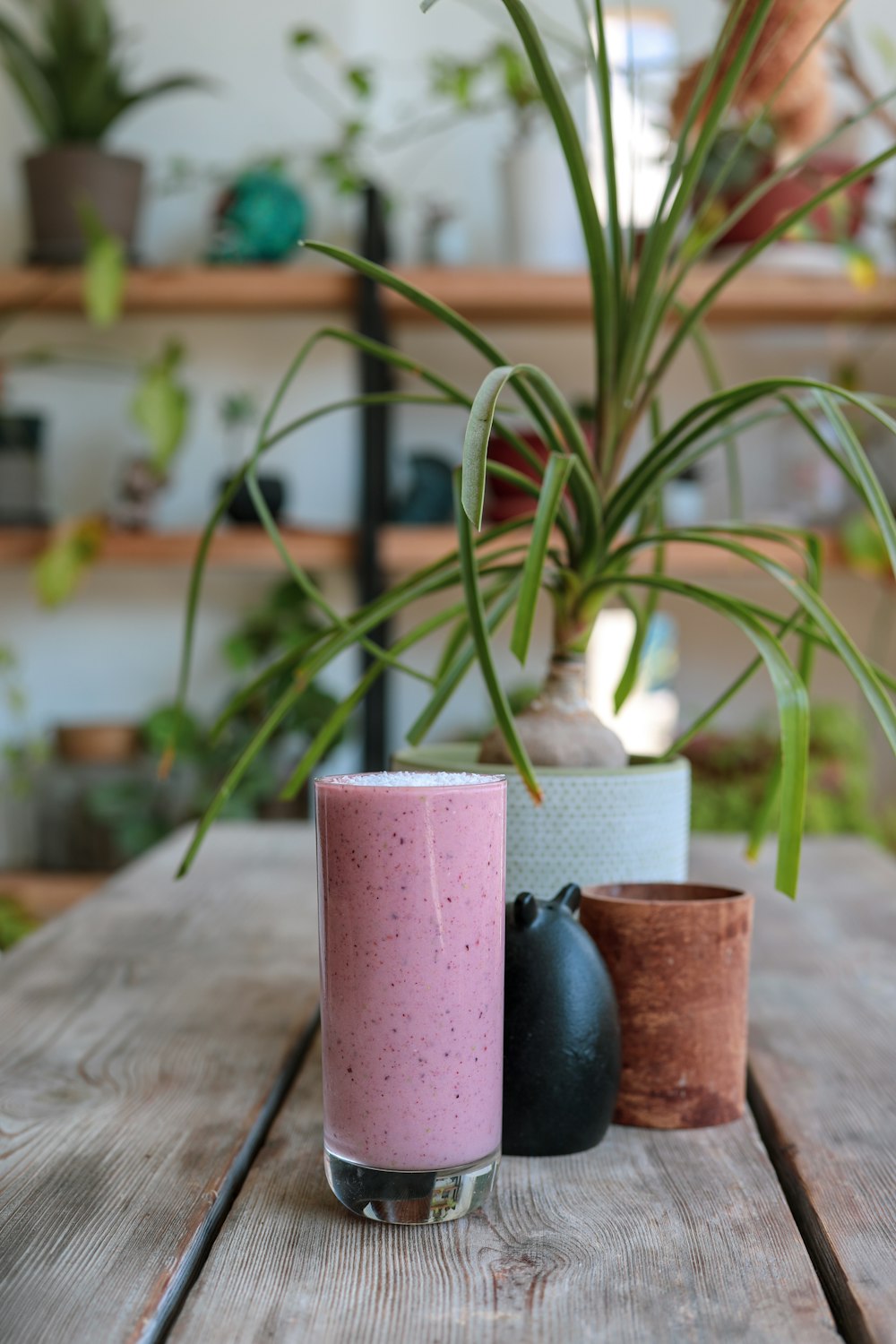 pink pillar candle on brown wooden table