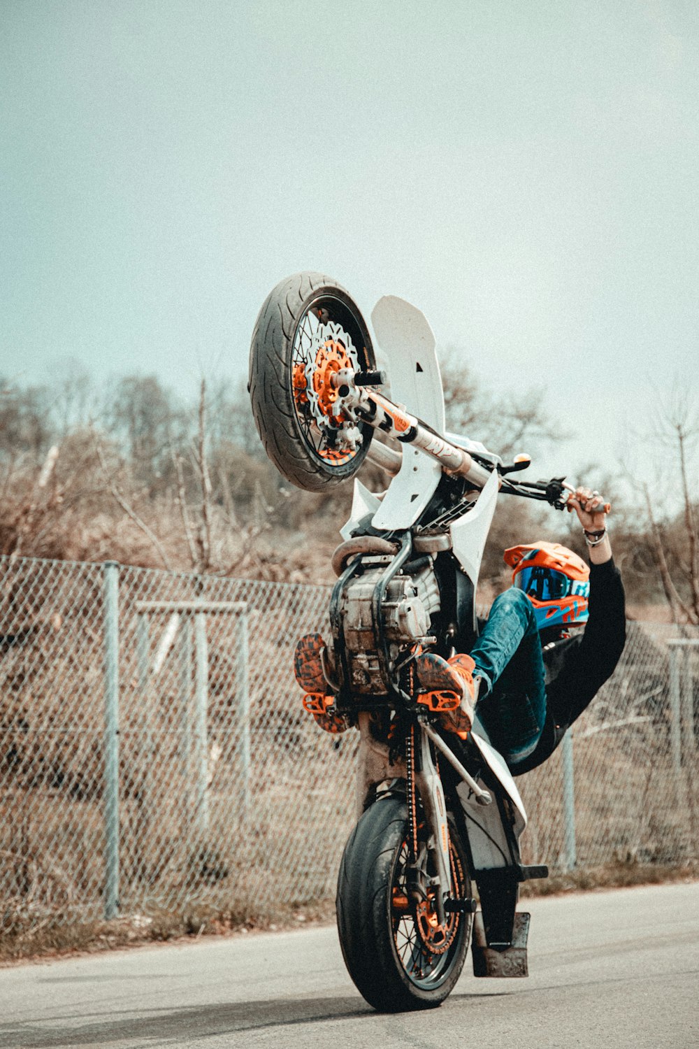 man in blue jacket and blue denim jeans riding bicycle