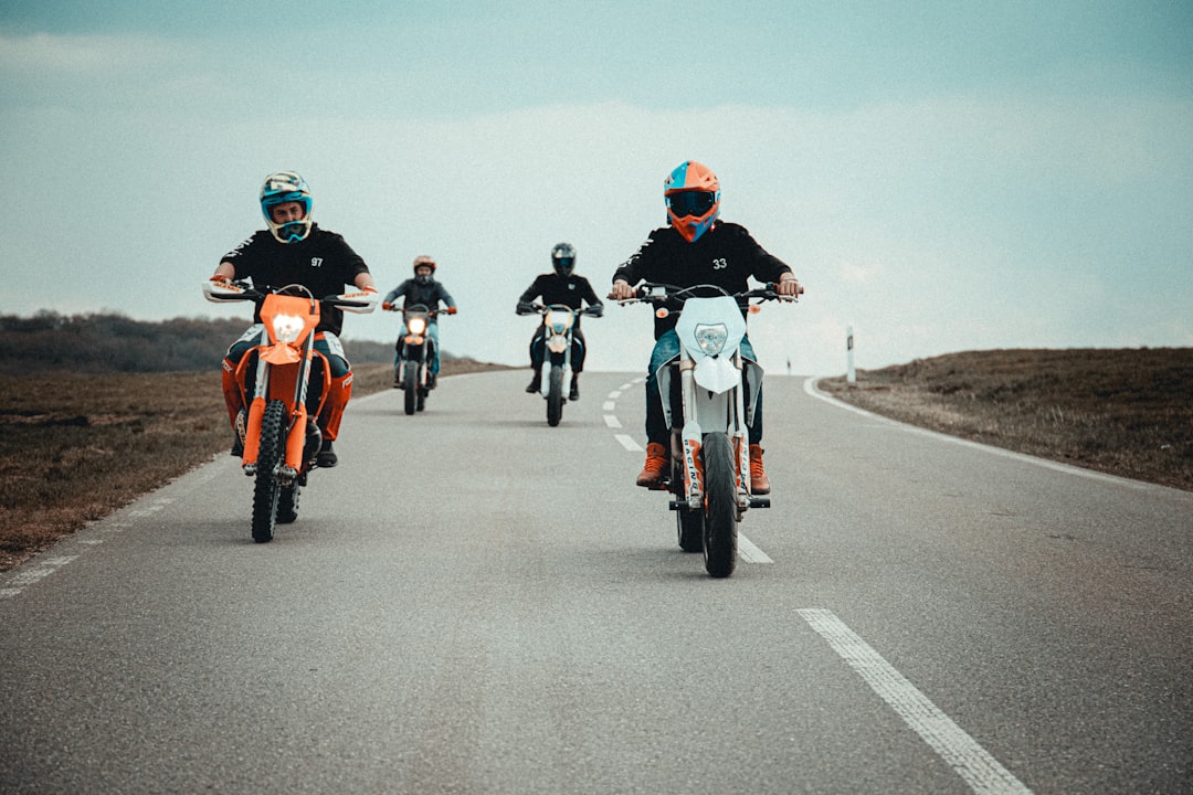 people riding motorcycle on road during daytime