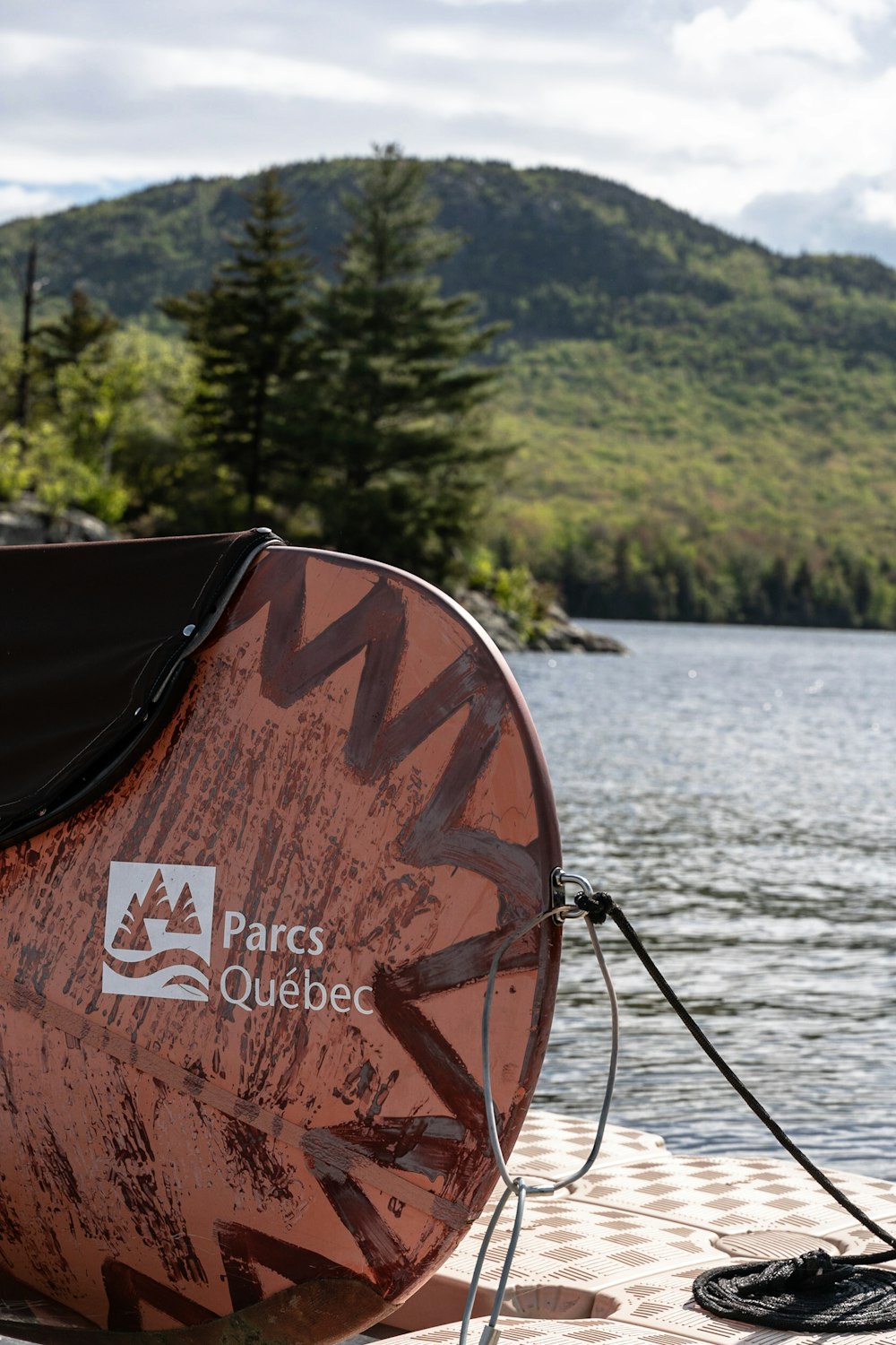 brown wooden boat on lake during daytime