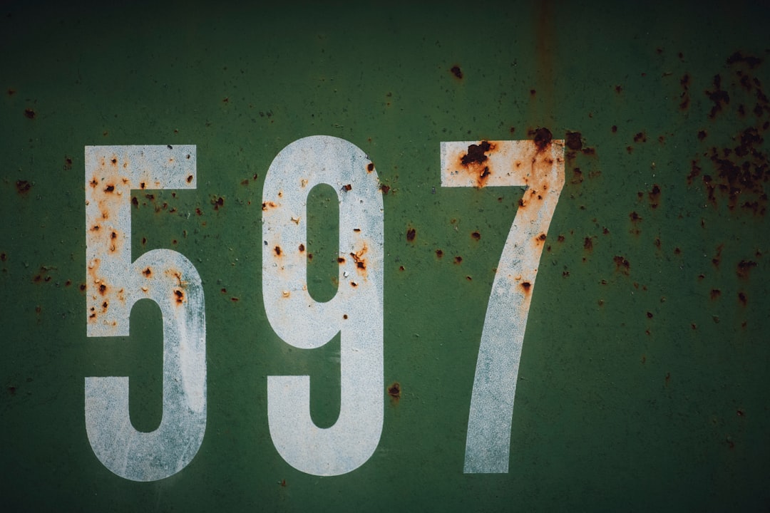 white and red number 10, 597 numbers rusty metal